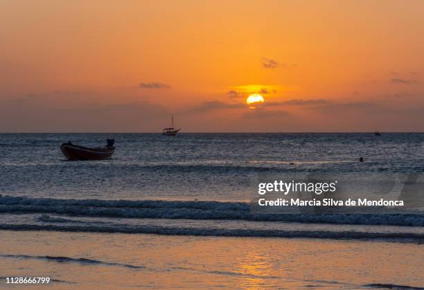 in the late afternoon enjoying the sunset on the beach of jericoacoara. - o anoitecer foto e immagini stock