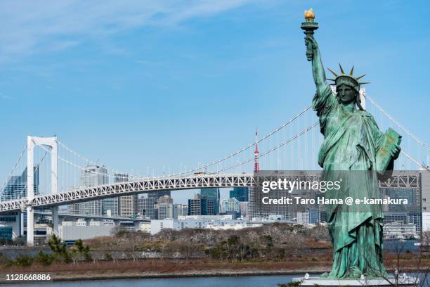 statue of liberty in odaiba, tokyo tower and rainbow bridge in tokyo in japan - replica statue of liberty odaiba stock pictures, royalty-free photos & images