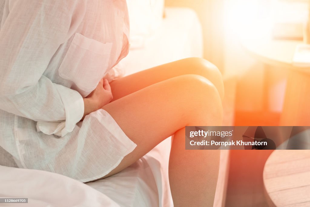 Pelvic pain stomachache concept. Hands of young woman on stomach as suffer on menstruation cramp, indigestion,gastrointestinal,diarrhea problem