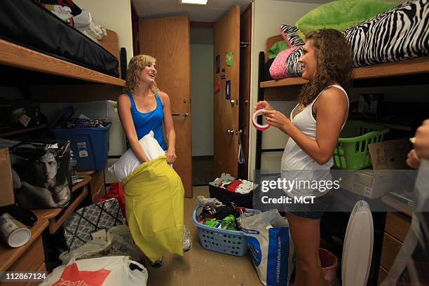 Danielle Sterczek of Palatine, Illinois, left, and her roommate Krysten Karns of Aledo, Illinois, meet for the first time in person as they move into...