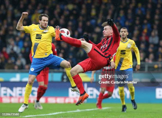 Stephan Fuerstner of Eintracht Braunschweig and Florian Hansch of SV Wehen Wiesbaden battle for the ball during the 3. Liga match between Eintracht...