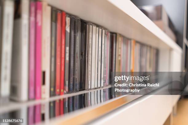 stack of cds in sideboard - cds stock pictures, royalty-free photos & images