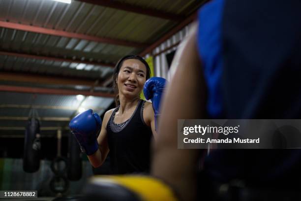 akha/thai woman in boxing gym - akha woman stock pictures, royalty-free photos & images