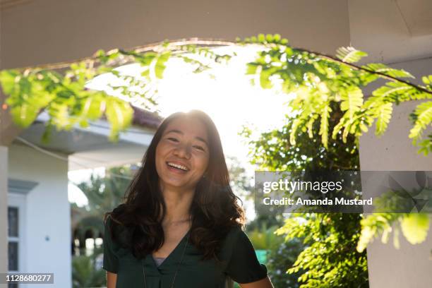 smiling akha/thai woman at home in sunlight - akha woman stock pictures, royalty-free photos & images