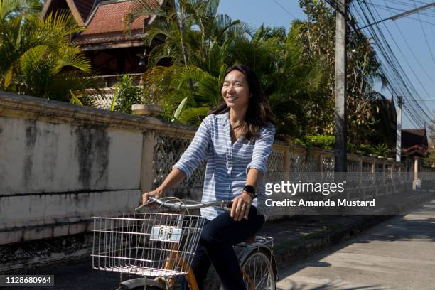 Happy Thai Woman Riding Bicycle with Basket