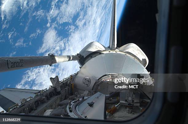 Backdropped by Earth's horizon and the blackness of space, the Leonardo Multi-Purpose Logistics Module is visible in Discovery's payload bay, Monday,...
