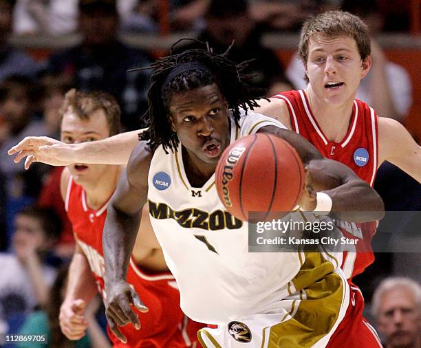 Missouri forward DeMarre Carroll recovers a loose ball as Cornell's Ryan Wittman and Alex Tyler give chase during game action in the first round of...