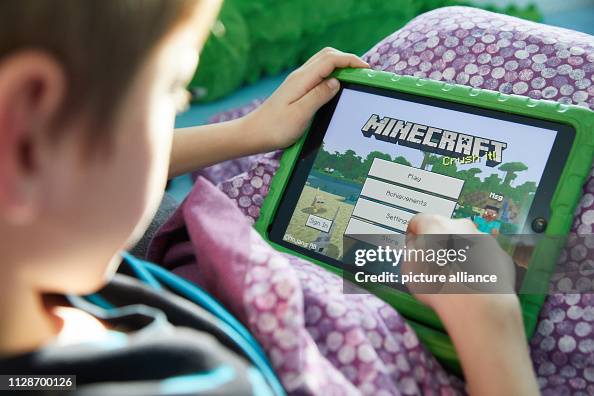 Computer Playing Mc Mingus plays the open world computer game Minecraft on his Ipad ...