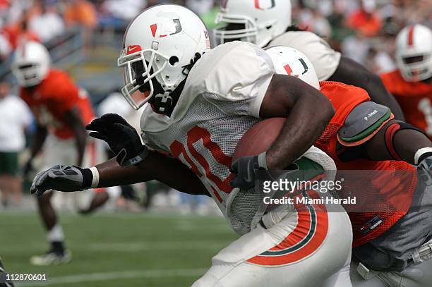 Miami's Damien Berry runs with the ball during the Hurricanes' football spring scrimmage game at Lockhart Stadium in Fort Lauderdale, Florida,...