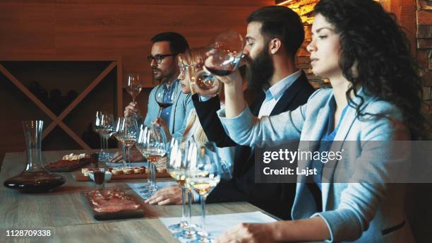 friends tasting wine together - taste test stock pictures, royalty-free photos & images
