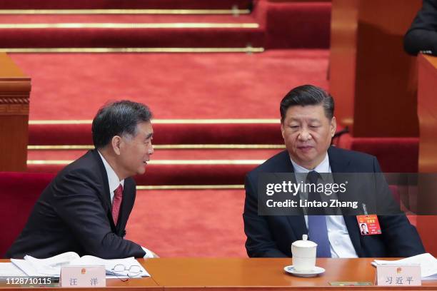 Chinese President Xi Jinping speaks with the Chairman of the Chinese People's Political Consultative Conference Wang Yang during the opening of the...