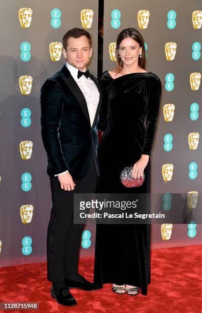 Taron Egerton and Emily Thomas attend the EE British Academy Film Awards at Royal Albert Hall on February 10, 2019 in London, England.