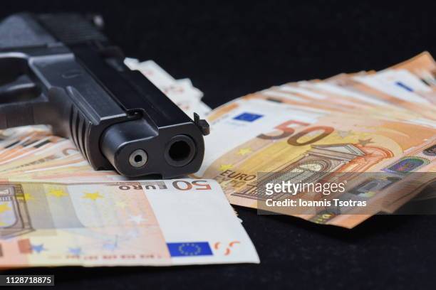 ull frame shot of fifty euro banknotes and a gun - gângster - fotografias e filmes do acervo