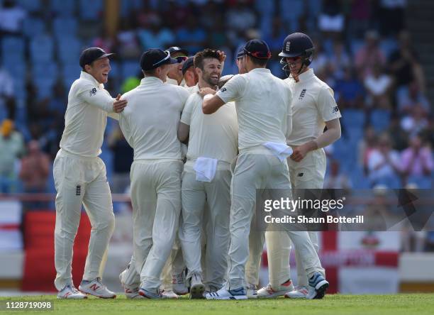 Mark Wood of England is congratulated by team-mates after taking the wicket of Darren Bravo of West Indies during Day Two of the Third Test match...