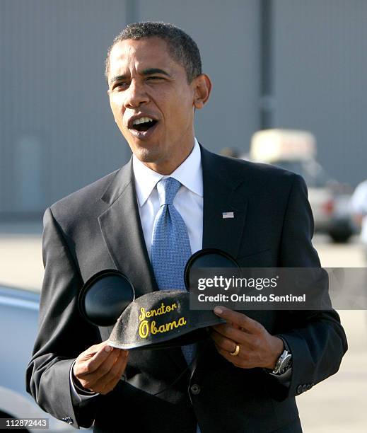 Democratic presidential candidate Sen. Barack Obama clowns around with Mickey Mouse ears during his arrival at Orlando International Airport in...