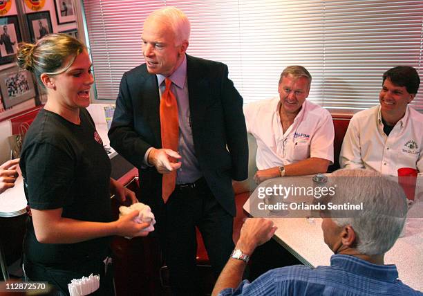 Presidential candidate Sen. John McCain chats with waitress Brandi Andrews, left, at the Starlite diner in Daytona Beach, Florida, Thursday, October...