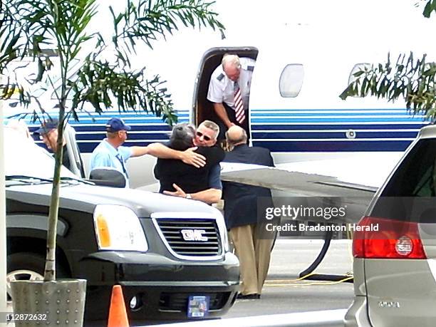 Keith Stansell hugs a family member as he exits a private plane at Volo Aviation at Sarasota Bradenton International Airport in Florida, Saturday,...