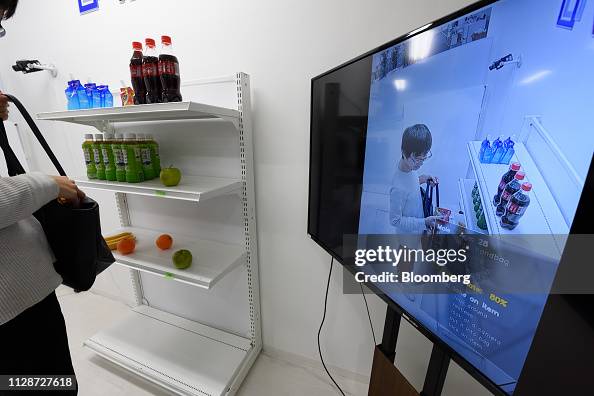 Vaak A screen displays a Vaak employee handling a product in a mock store ...