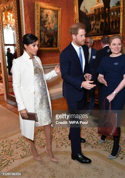 Meghan, Duchess of Sussex and Prince Harry, Duke of Sussex attend a reception to mark the fiftieth anniversary of the investiture of the Prince of...