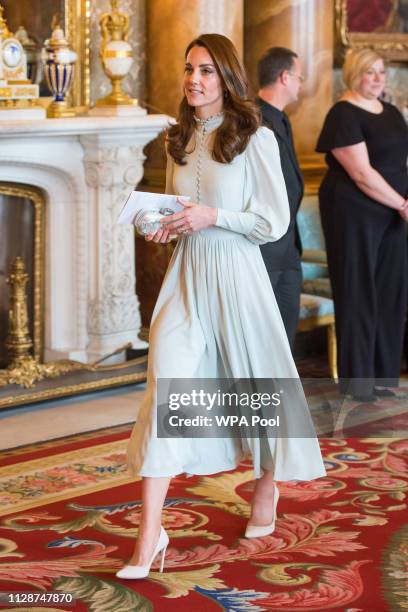 Catherine, Duchess of Cambridge attends a reception to mark the fiftieth anniversary of the investiture of the Prince of Wales at Buckingham Palace...