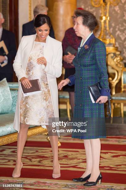 Meghan, Duchess of Sussex and Princess Anne, Princess Royal attend a reception to mark the fiftieth anniversary of the investiture of the Prince of...