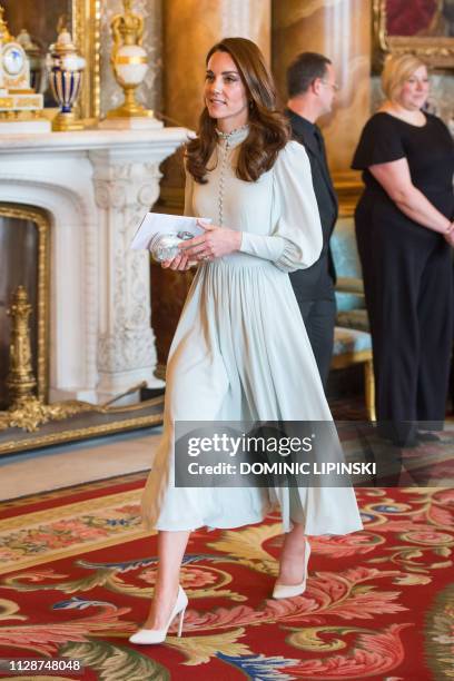 Britain's Catherine, Duchess of Cambridge, attends a reception to mark the 50th Anniversary of the investiture of The Prince of Wales at Buckingham...