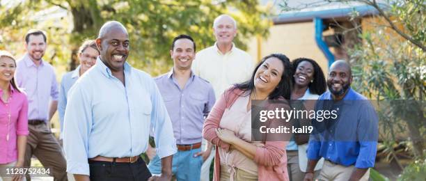 corporate team building, group of adults outdoors - happy colleagues doing team building activity imagens e fotografias de stock