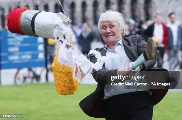 Junior Minister for Health Catherine Byrne smashes a pinata full of cigarette butts as she launches the campaign for a tobacco free campus for...