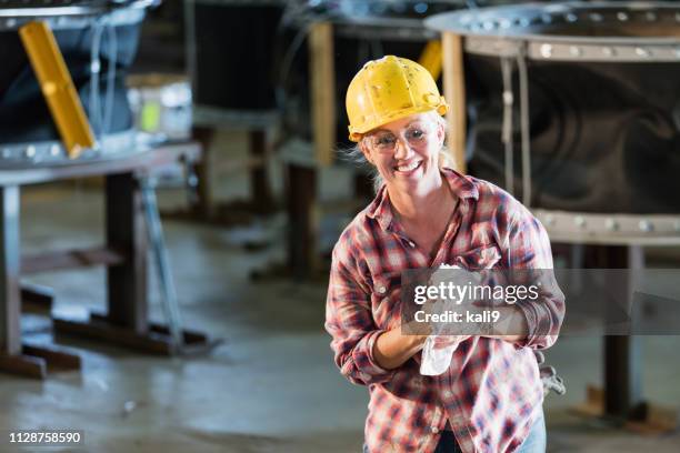 mature woman in metal fabrication plant - rag stock pictures, royalty-free photos & images