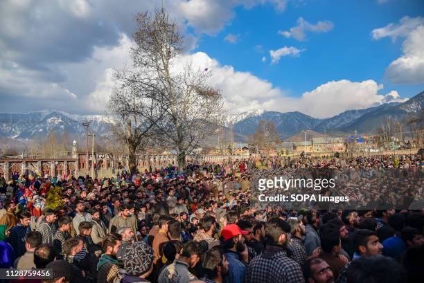 Kashmiri residents are seen watching the funeral ceremony of slain Irfan Ahmad Rather at Shareefabad Tral. Thousands attend the funeral procession of...