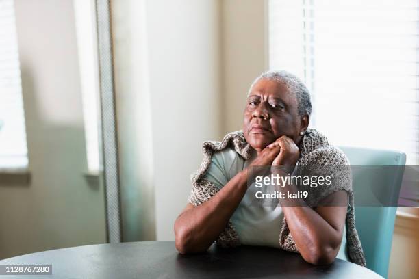 lonely senior african-american woman at home - angry black woman stock pictures, royalty-free photos & images