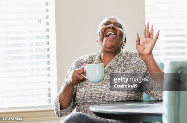 gelukkig senior afro-amerikaanse vrouw thuis, koffie - fat woman funny stockfoto's en -beelden