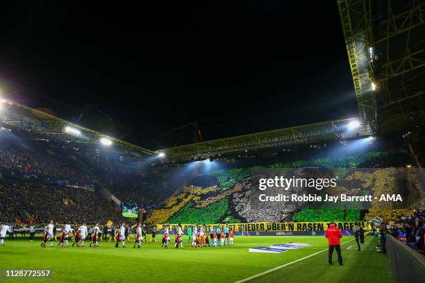 General view as both teams walk out and fans of Borussia Dortmund hold up tifo during the UEFA Champions League Round of 16 Second Leg match between...