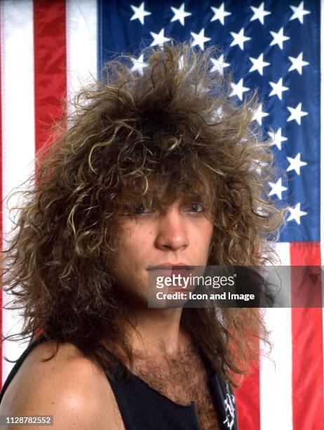 American singer-songwriter, actor and namesake of the rock band Bon Jovi poses for a portrait in front of the American flag, June in Detroit, MI.