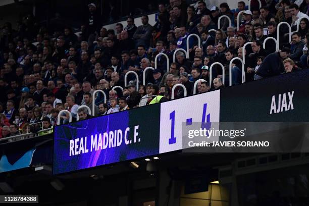 The score board is pictured during the UEFA Champions League round of 16 second leg football match between Real Madrid CF and Ajax at the Santiago...