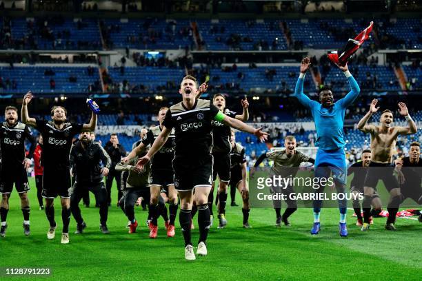 Ajax's players celebrate at the end of the UEFA Champions League round of 16 second leg football match between Real Madrid CF and Ajax at the...