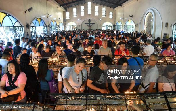 Catholic devotees pray on 'Ash Wednesday' at a church in Manila on March 6, 2019. - The 40-day period of Lent begins on Ash Wednesday, with Catholics...