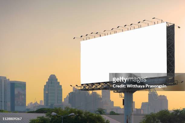 road with lanterns and large blank billboard at evening in city : bangkok : thailand - billboard highway stock-fotos und bilder