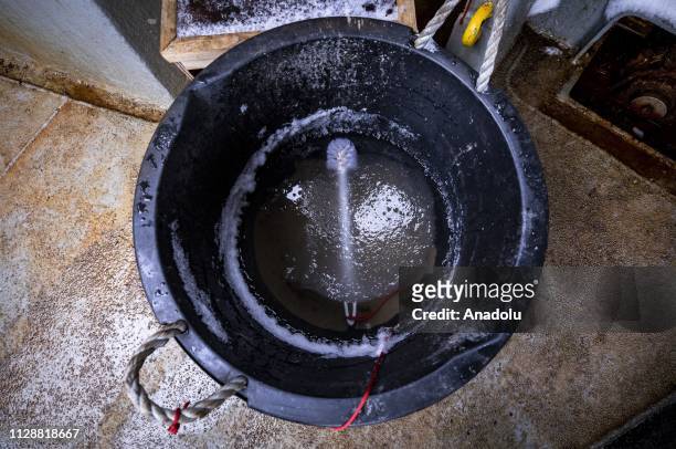 Bucket used for cleaning shoes freeze due to extreme cold weather at the sailing under the colors of Chile, the Betanzos ship to land on February 07,...