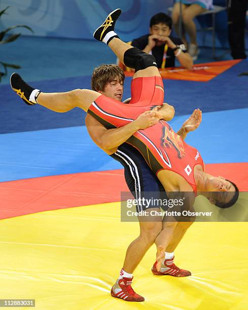 Denis Forov of Armenia, in blue, battles Shingo Matsumoto of Japan in Greco Roman wrestling on Thursday, August 14 in the Games of the XXIX Olympiad...