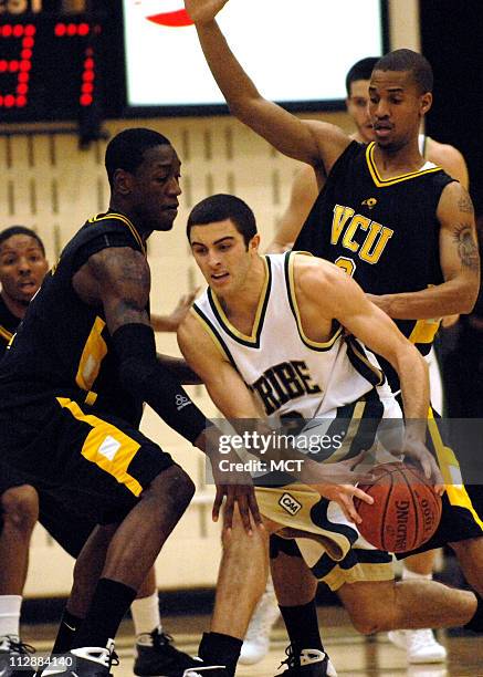 William and Mary guard David Schneider attempts to work out of a double team by Virginia Commonweath University's Larry Sanders and Eric Maynor...