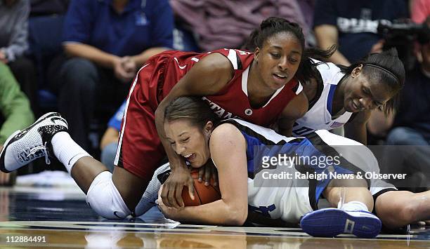 Duke guard Abby Waner and teammate Bridgette Mitchell wrestle with Stanford forward Nnemkadi Ogwumike during first half action at Cameron Indoor...