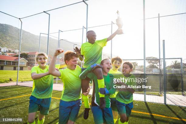 boys soccer team celebrating with trophy - soccer team stock pictures, royalty-free photos & images