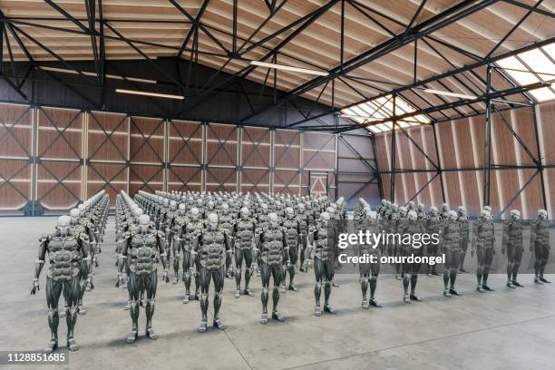 group of robots in warehouse - robot army stock pictures, royalty-free photos & images