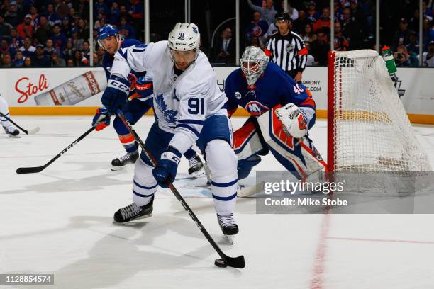 John Tavares of the Toronto Maple Leafs skates against Robin Lehner of the New York Islanders at NYCB Live's Nassau Coliseum on February 28, 2019 in...