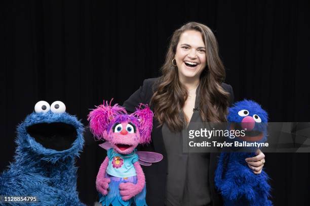 Portrait of Sports Illustrated via Getty Images senior writer and host Charlotte Wilder posing with Cookie Monster, Abby Cadabby, and Grover of...