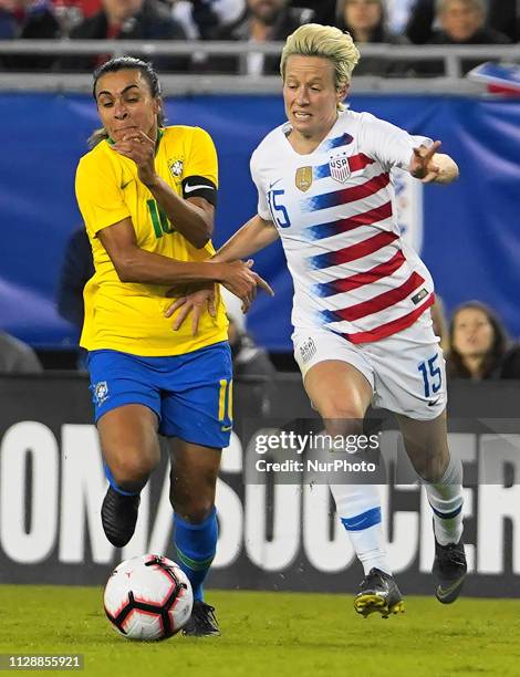 Megan Rapinoe of The United States tackle with Marta of Brazil during the SheBelieves Cup match between The United States and Brazil at Raymond James...