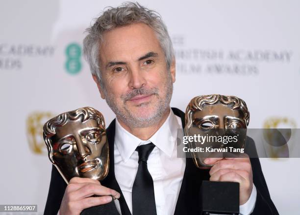 Winner of the Best Director and Best Film awards for Roma, director Alfonso Cuaron poses in the press room at the EE British Academy Film Awards at...