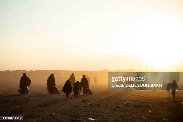 Women and children evacuated from the Islamic State group's embattled holdout of Baghouz arrive at a screening area held by the US-backed Kurdish-led...