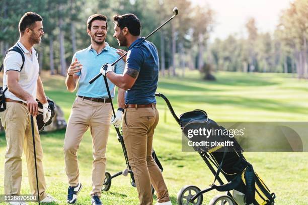 group of golf players talking and laughing - golf excitement stock pictures, royalty-free photos & images